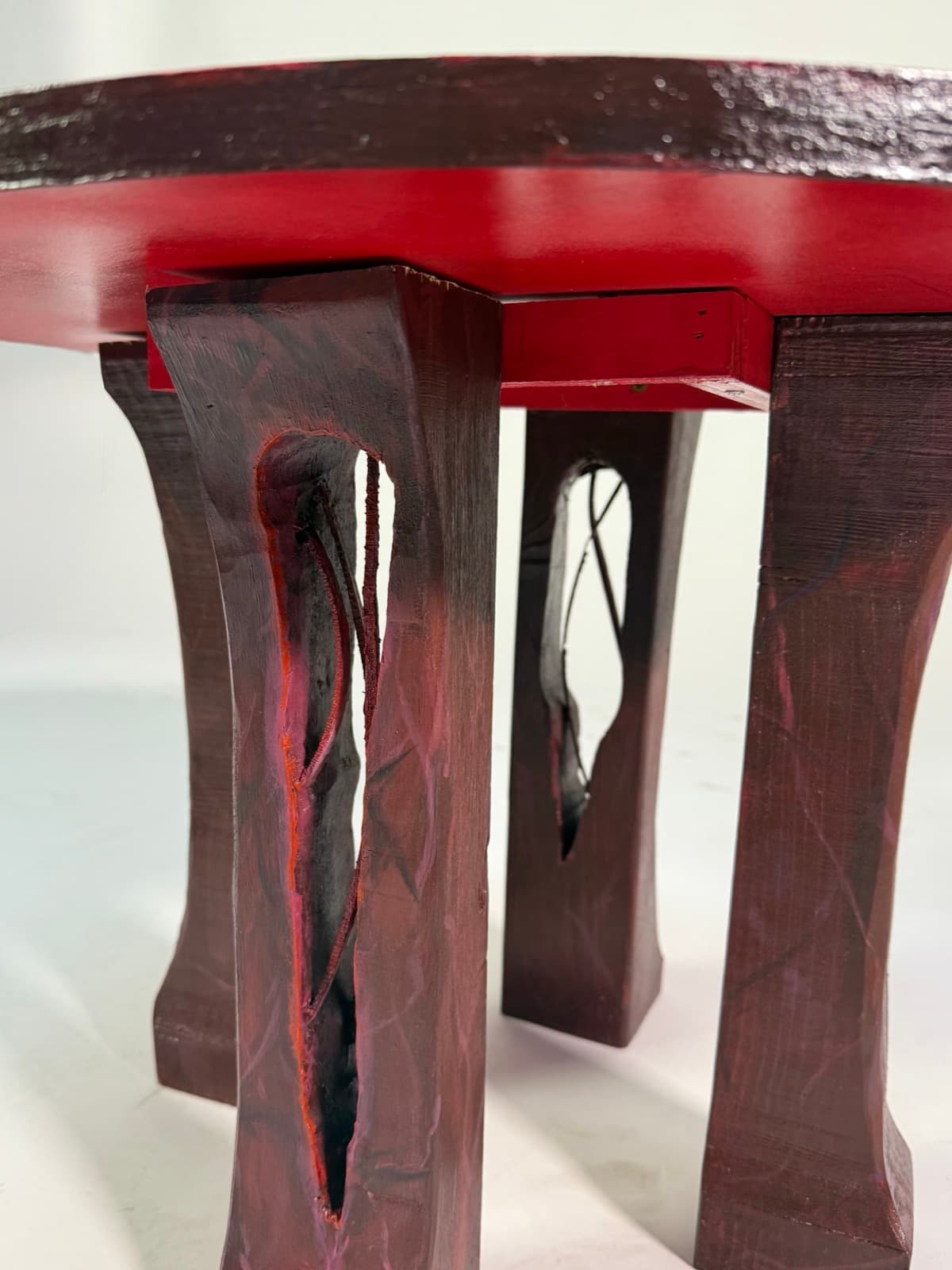 Close-up detail of the eye table's carved wooden legs