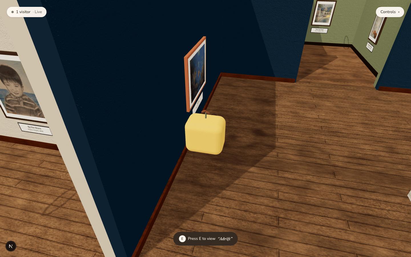 An avatar standing beside a hung painting with a 'Press E to view Adrift' interaction prompt at the bottom of the screen.