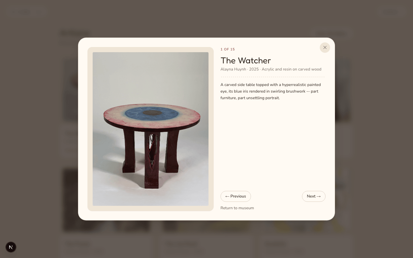 Focused artwork viewer showing 'The Watcher,' a carved side table with a painted eye, its title, medium, and description, numbered 1 of 15.